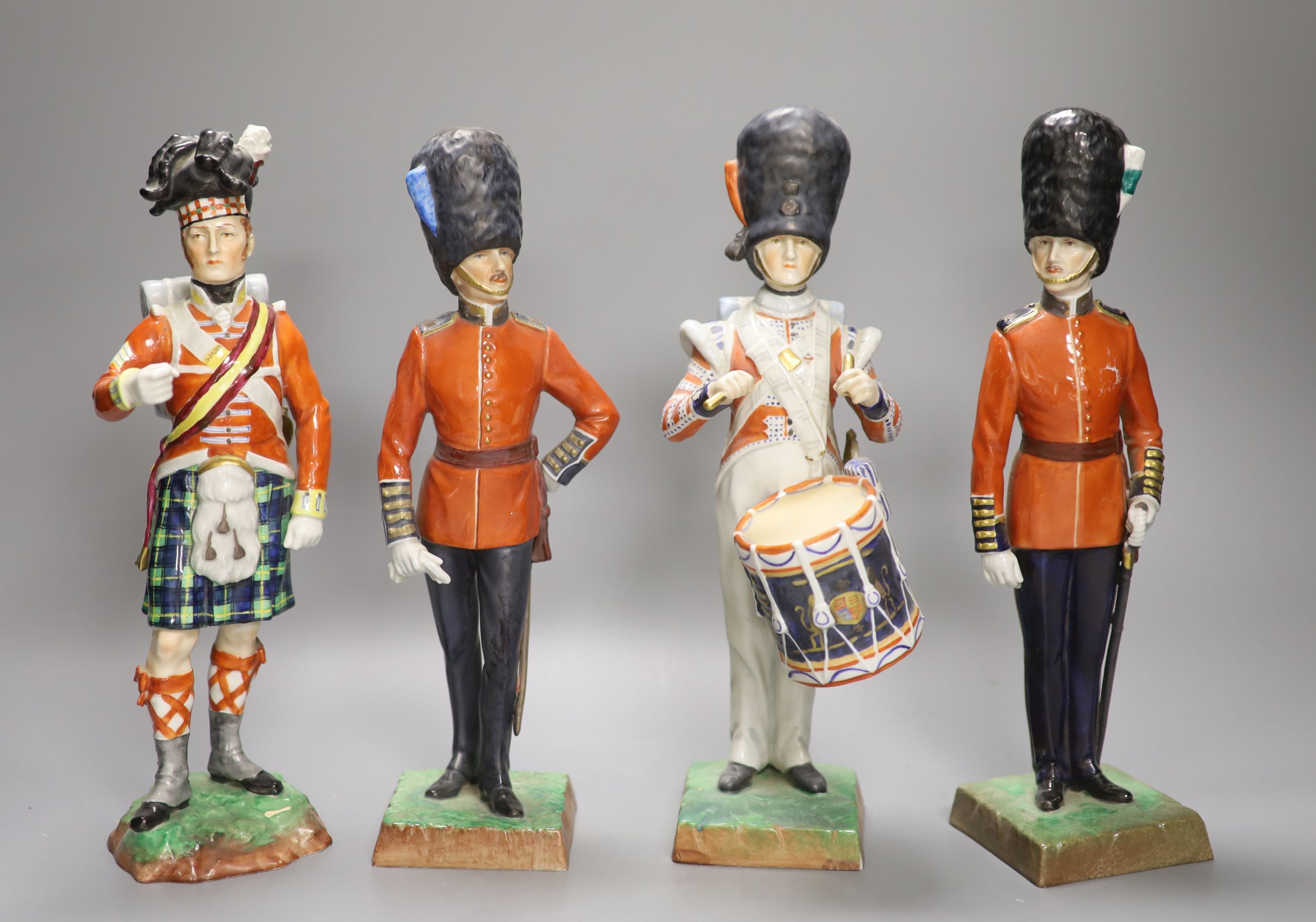 Four Dresden porcelain models of soldiers: Irish Guards, Drummer 3rd Guards, The Welsh Guards and Gordon Highlanders, height 28cm